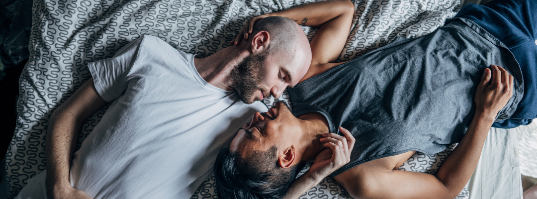 gay couple relaxing in bed